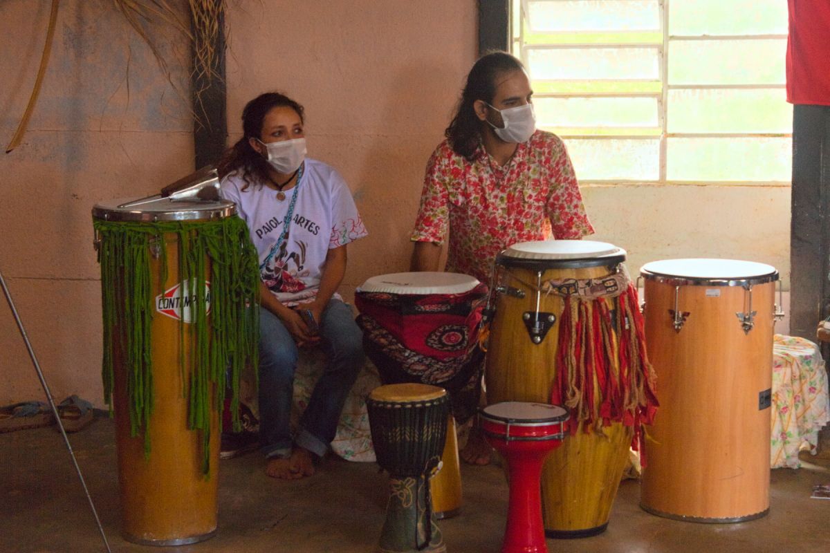 Two people sitting behing parcussion instruments.